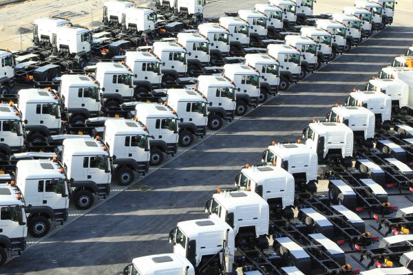 Many trucks are in a storage area