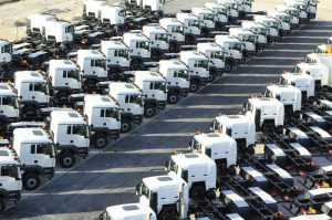 Lots of trucks standing in a storage yard